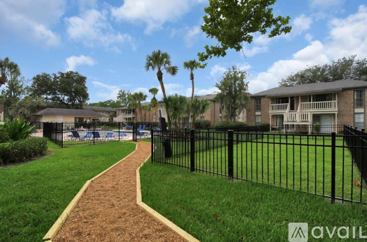 A residential area with a walking path and apartment buildings.