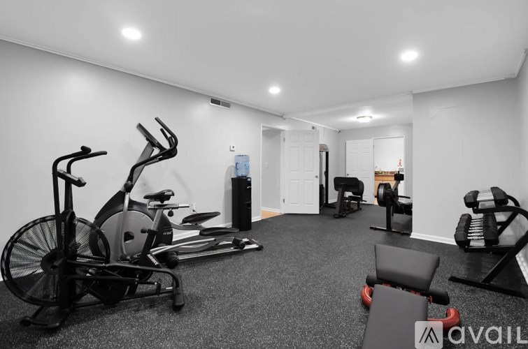 A spacious home gym with a variety of exercise equipment.
