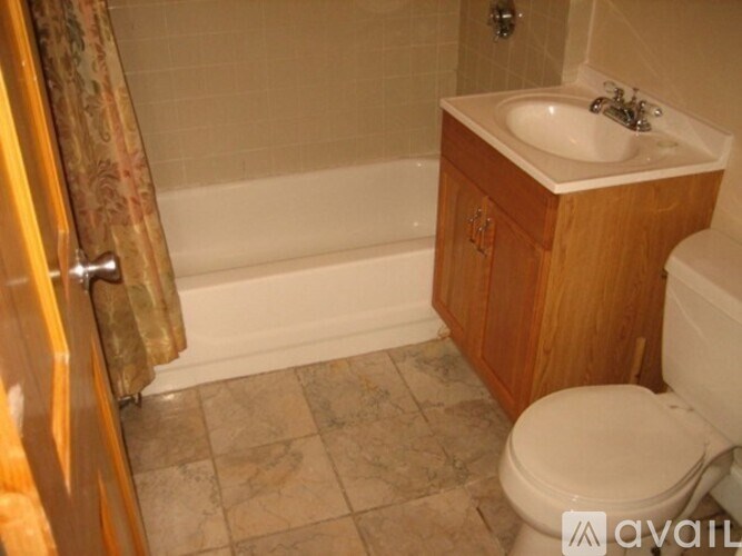 A bathroom with a toilet, sink, and bathtub.
