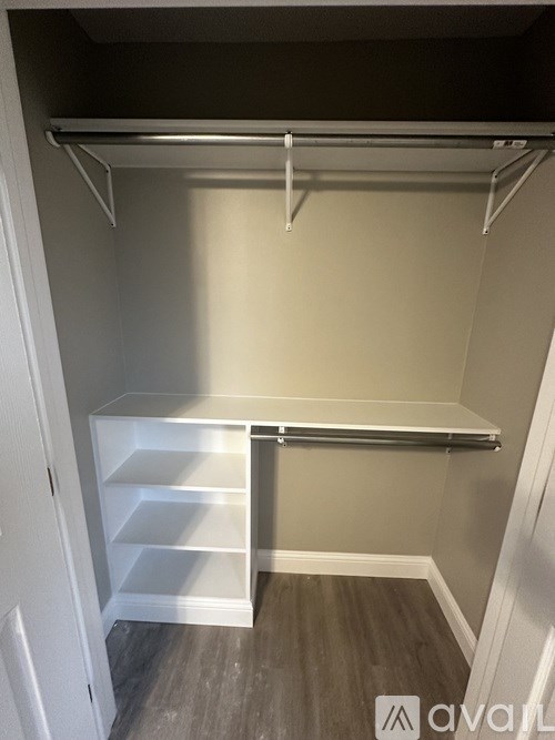 A small, empty closet with a shelf and a hanging rod.