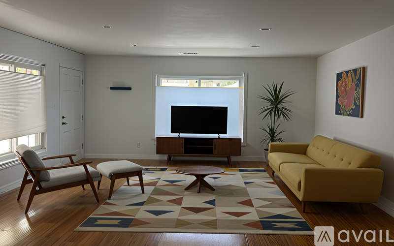 A living room with a yellow couch, a wooden coffee table, and a television.