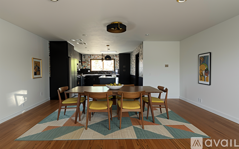 A dining room with a wooden table and chairs.