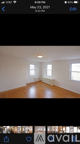 A room with wooden floors and two windows.