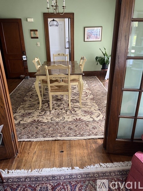 A dining room with a table and chairs.