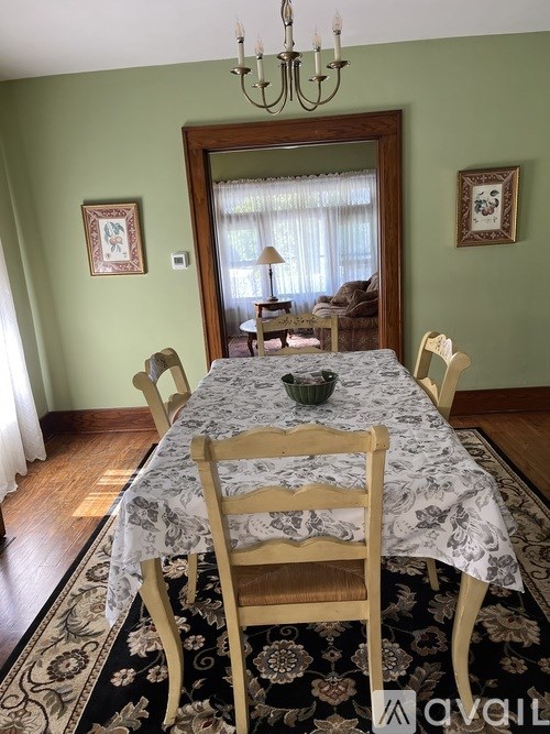 A dining room with a table set for four.
