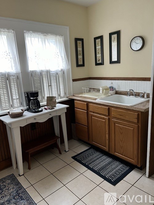A kitchen with a white table and a sink.