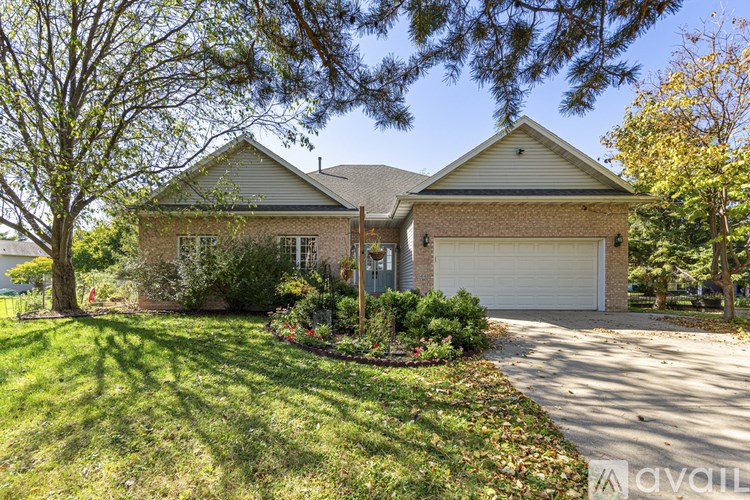 A house with a garage and a driveway is for sale.