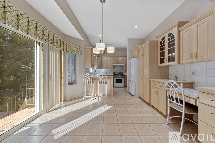 A kitchen with wooden cabinets and a tiled floor.