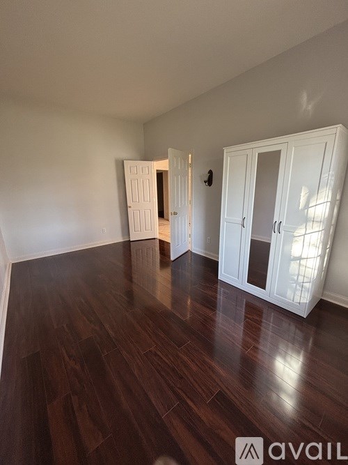 A room with wooden floors and white walls.