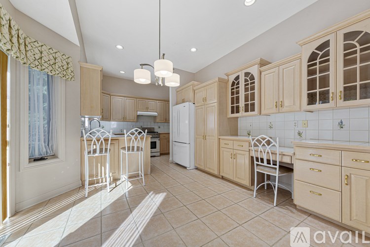 A kitchen with wooden cabinets and a tiled floor.