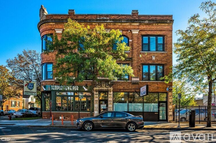 A car is parked in front of a building with a sign that says Temple Gate Pub.