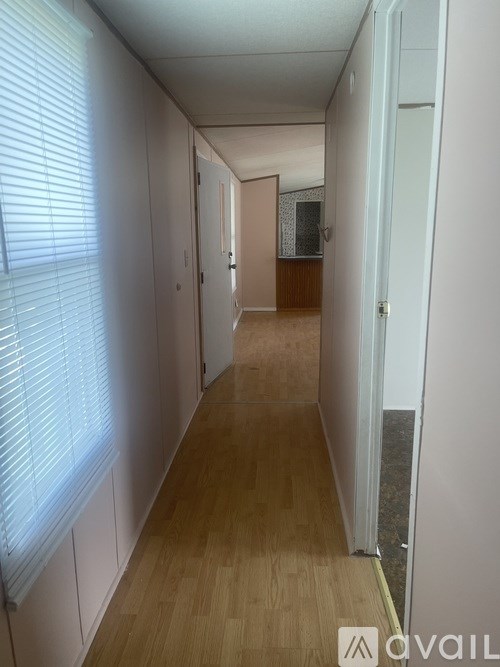 A long hallway with a door on the right.