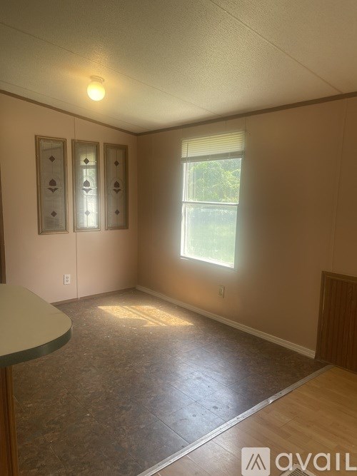 A room with a window and a table.