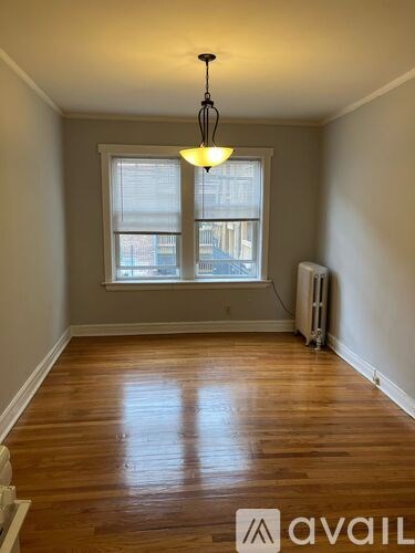 A room with wooden floors and a window.