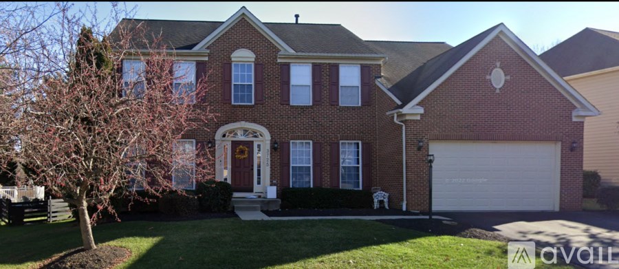 A red brick house with a white dog.