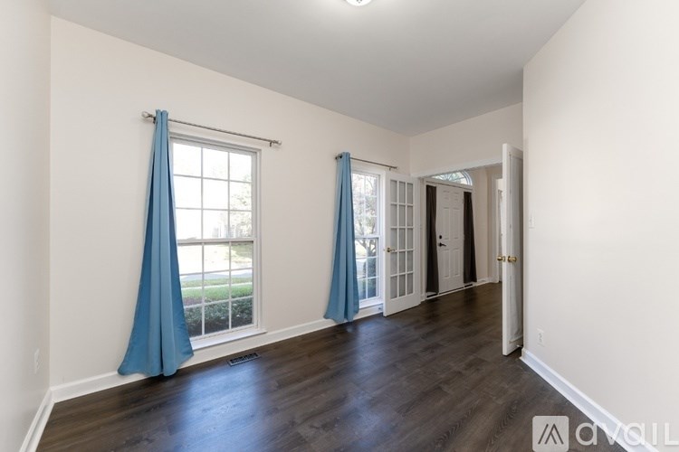 A room with a window and a door is available for rent.