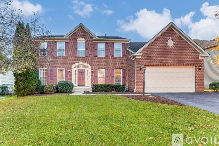 A red brick house with a white garage door.