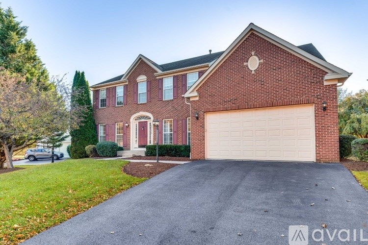 A red brick house with a white garage door.
