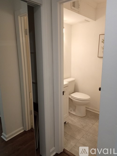 A white toilet in a small bathroom.
