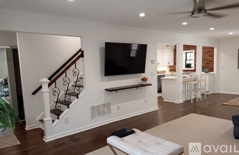 A living room with a staircase leading to the upper floor.