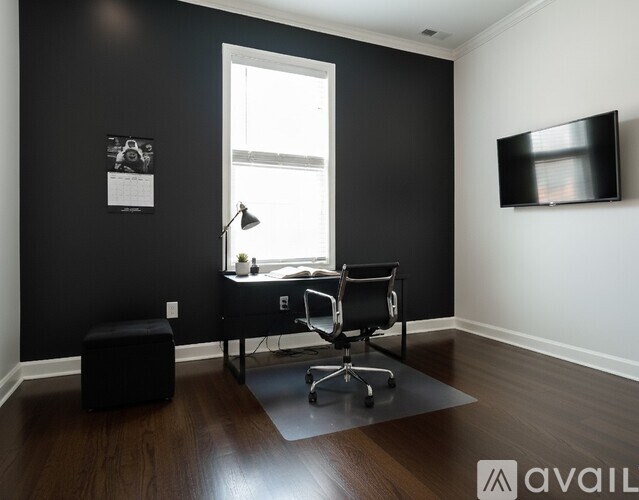 A room with a wooden floor and a white door.