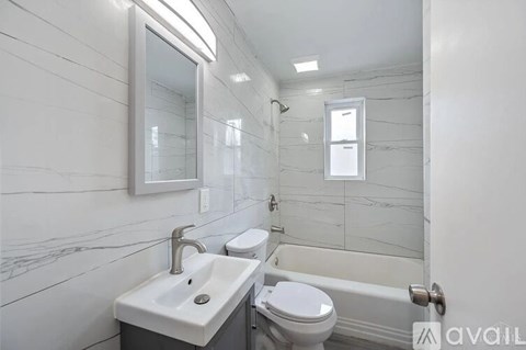 A bathroom with a sink, toilet, and bathtub.