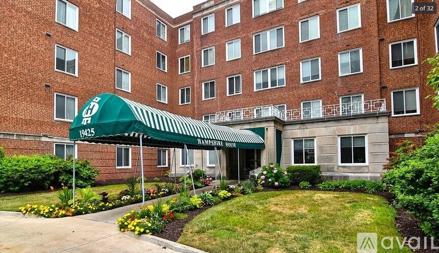 A large brick building with a green awning and the number 19425 on it.