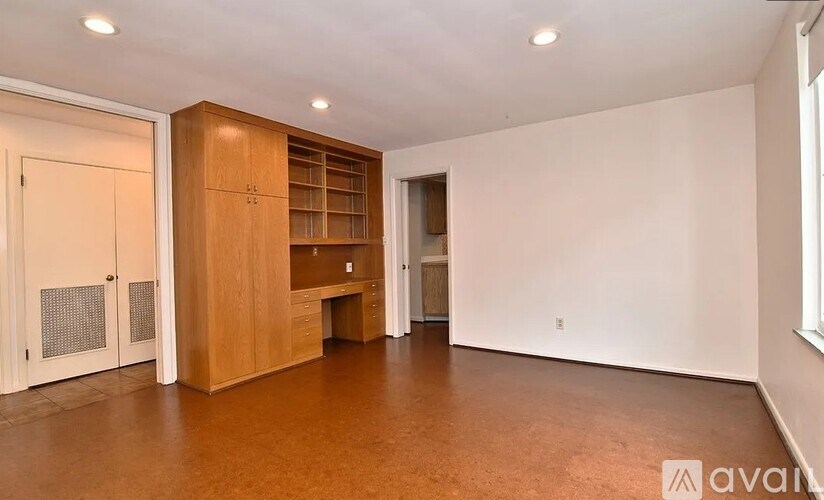 A room with wooden floors and furniture.