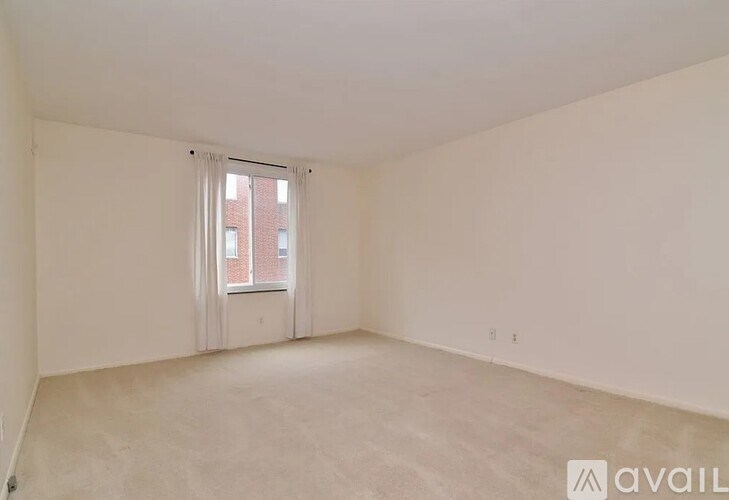 Empty room with a window and a sign that says "available".
