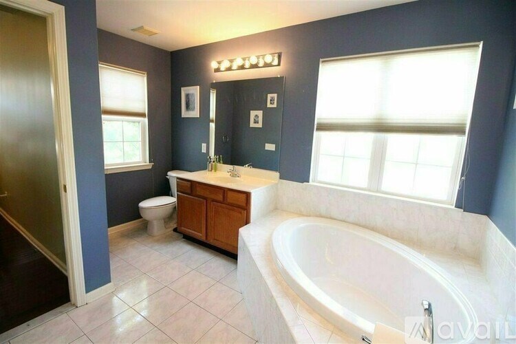 A bathroom with a tub, toilet and sink.