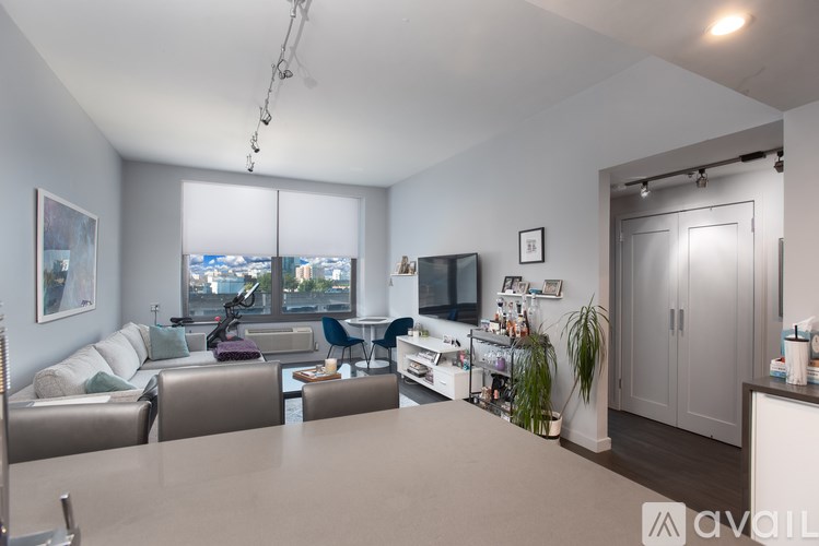A modern living room with a large window and a flat screen TV.