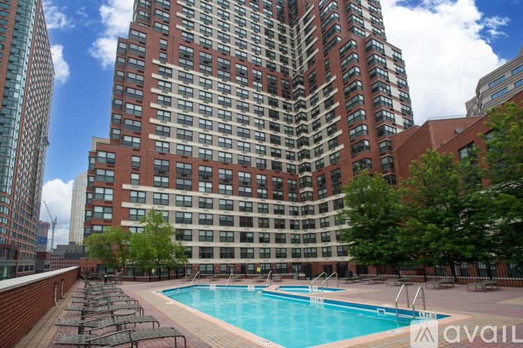 A large building with a pool in front of it.