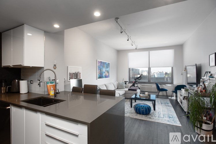 A modern kitchen with white cabinets and a large island.