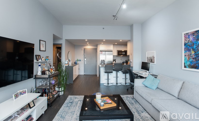A living room with a grey couch and a coffee table in the center.