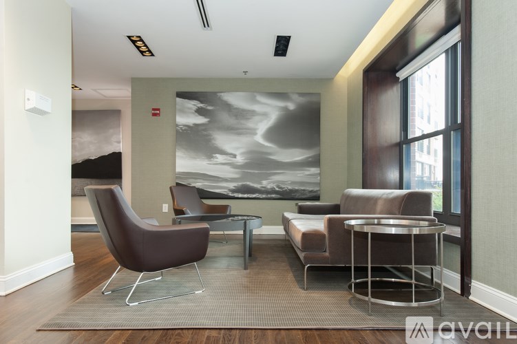 A living room with a grey sofa, a brown armchair and a coffee table.