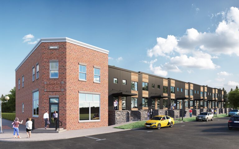 A modern building with a parking lot in front.