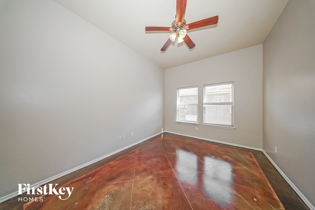 A room with a fan and a window.