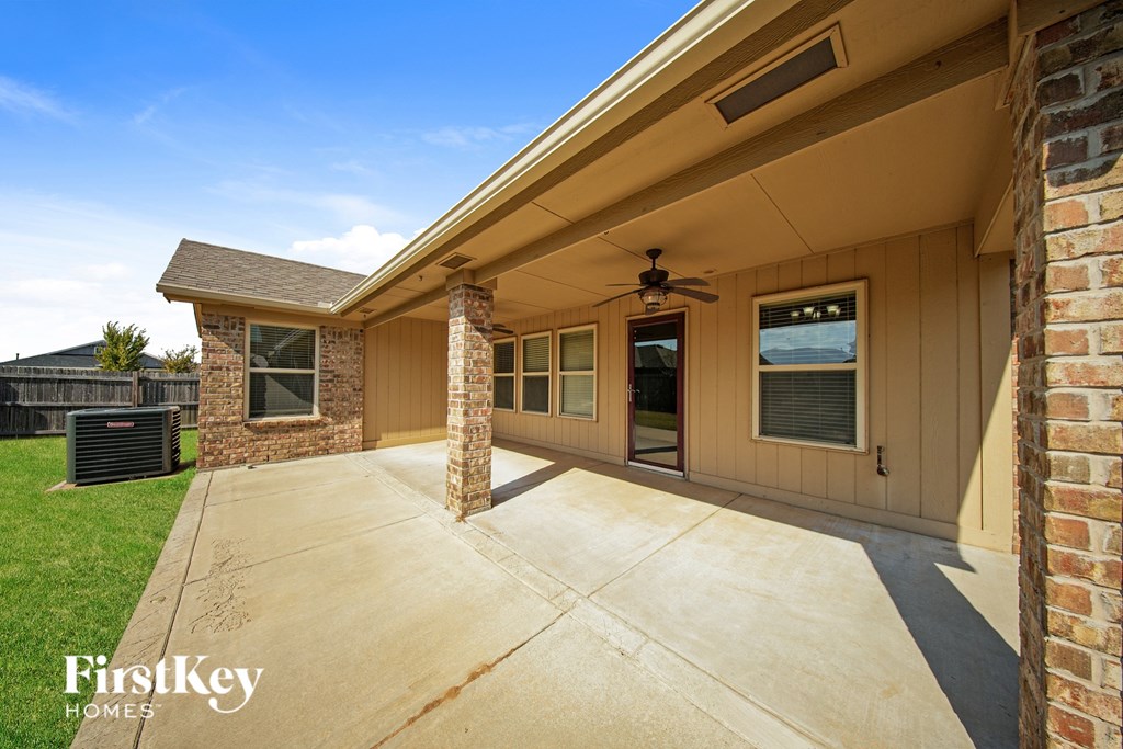 A house with a beige exterior and a large front porch.