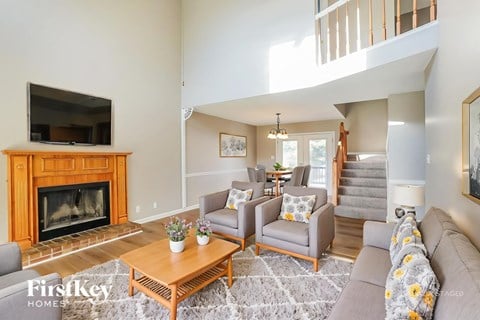 A living room with a fireplace and a television.