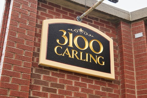 A sign on a brick wall that says 3100 Carling.