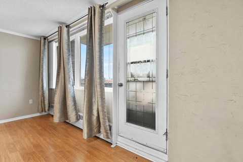 A room with a sliding door and curtains.