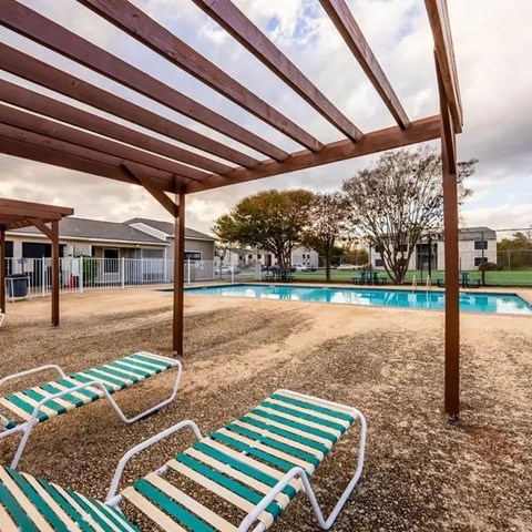 A sunny day at the pool with a shaded area.