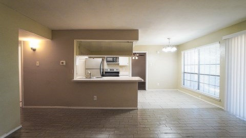 A kitchen area with a refrigerator, microwave, and oven.