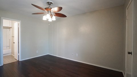 A room with a ceiling fan and lights.