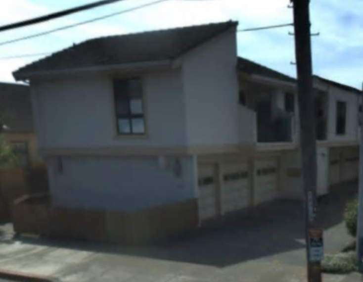 A small white house with a brown roof and a brown fence.