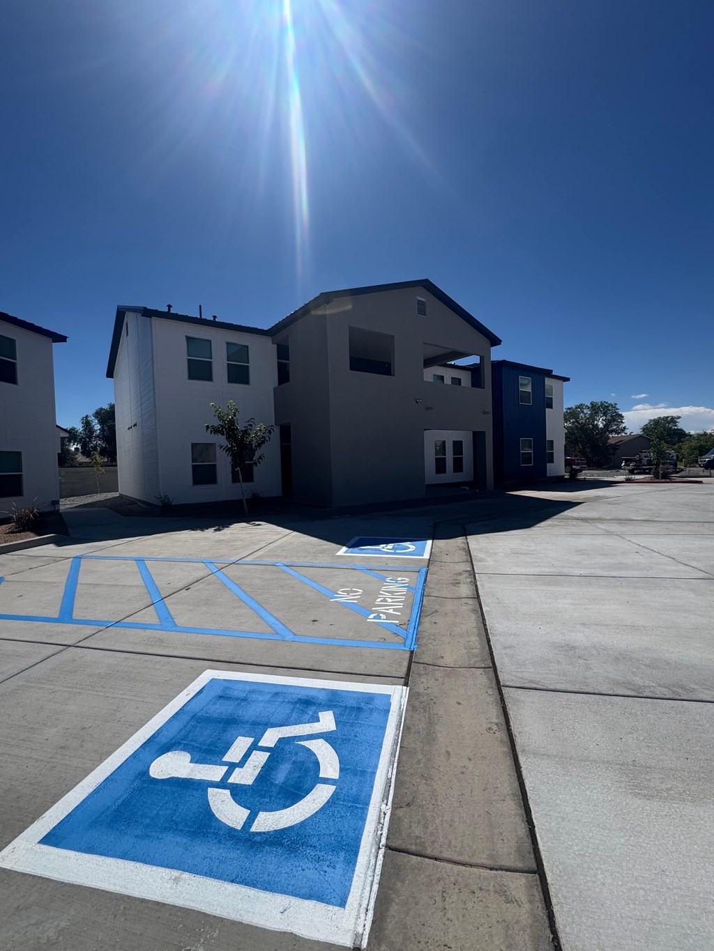 A sunny day at a parking lot with a handicap parking space.