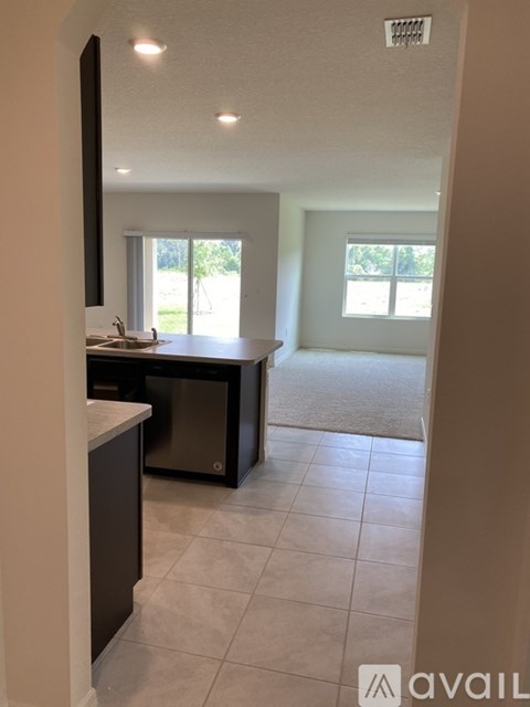 A kitchen with a sink and a window.