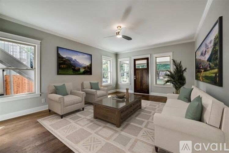 A living room with a large couch, a chair, and a coffee table.