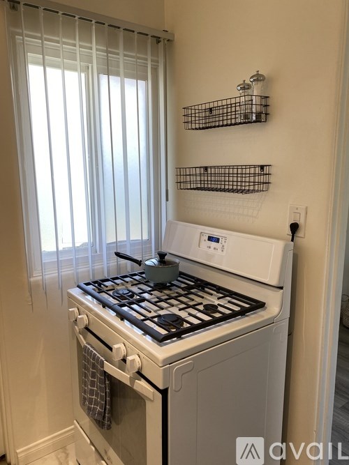 A white stove top oven with a pot on it.