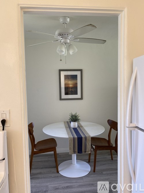 A small dining room with a round table and chairs.
